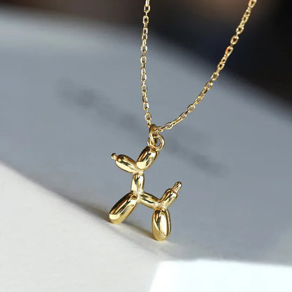 Gold-colored necklace with balloon dog pendant