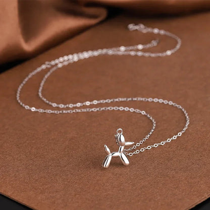 Gold-colored necklace with balloon dog pendant