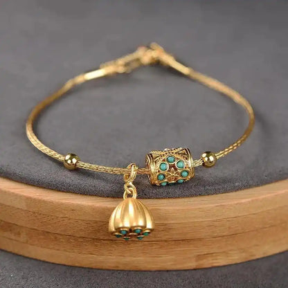 Armbånd i antikguld med turkis lotusblomst