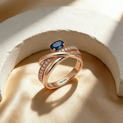 Vintage rose gold-plated cross ring with blue cubic zirconia