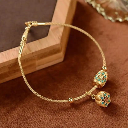 Armbånd i antikguld med turkis lotusblomst