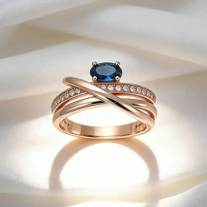 Vintage rose gold-plated cross ring with blue cubic zirconia