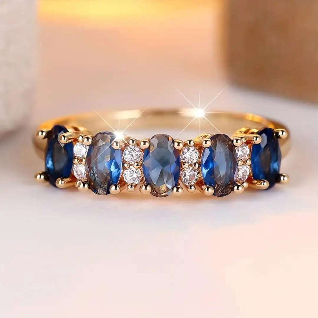 Oval ring med skiftende sten