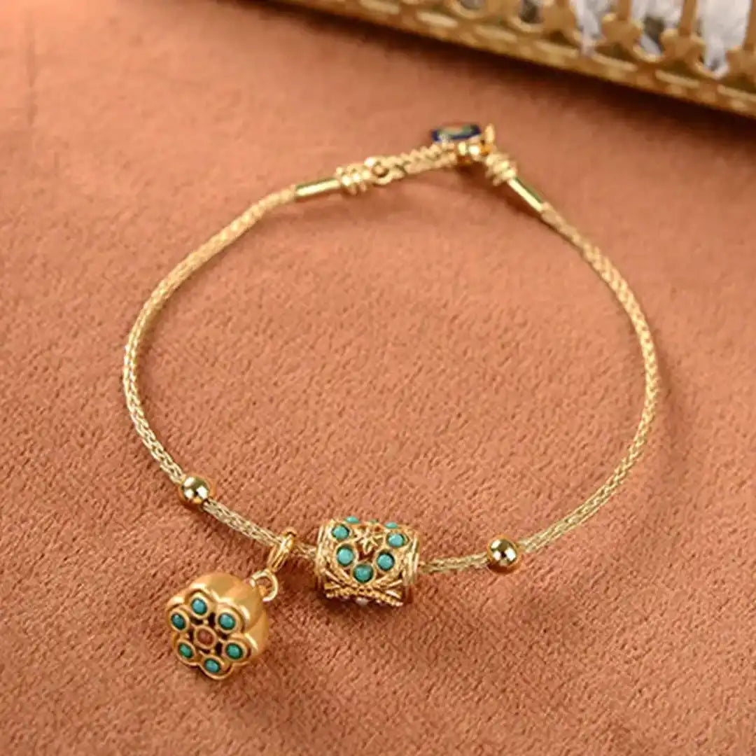 Armbånd i antikguld med turkis lotusblomst