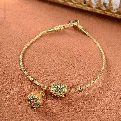 Armbånd i antikguld med turkis lotusblomst